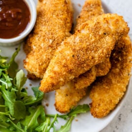 Air fryer chicken tenders on a white plate