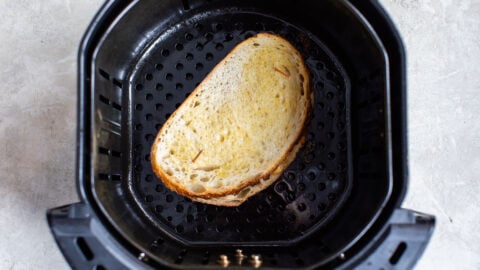 An uncooked sandwich in the basket of an appliance