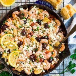 A skillet with Mediterranean Shrimp with garlic and feta