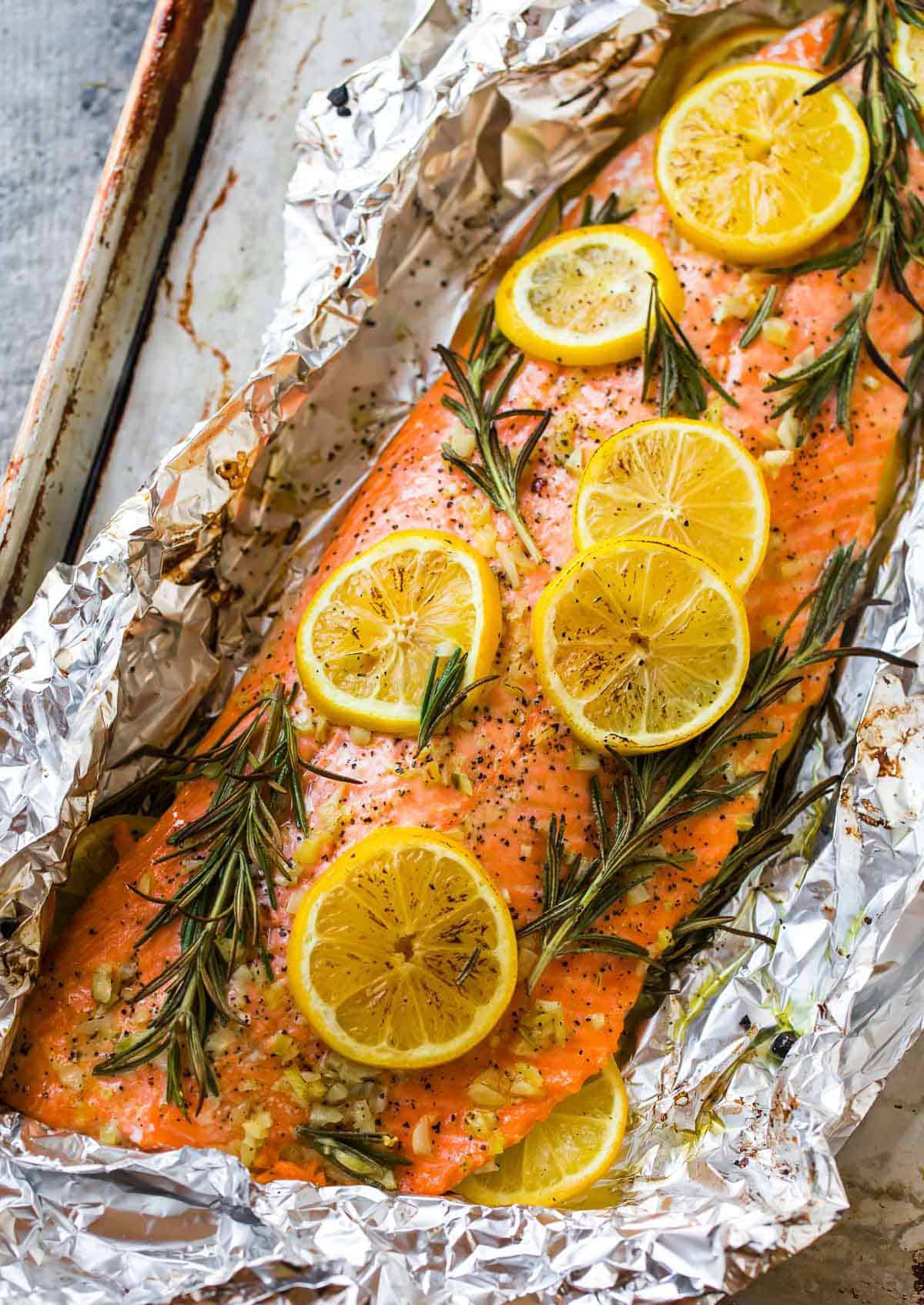easy baked salmon on a sheet pan with lemon and herbs on top