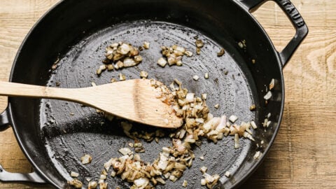 A shallot being sauteed in a skillet