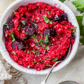 A bowl of vegetarian beet risotto with a spoon