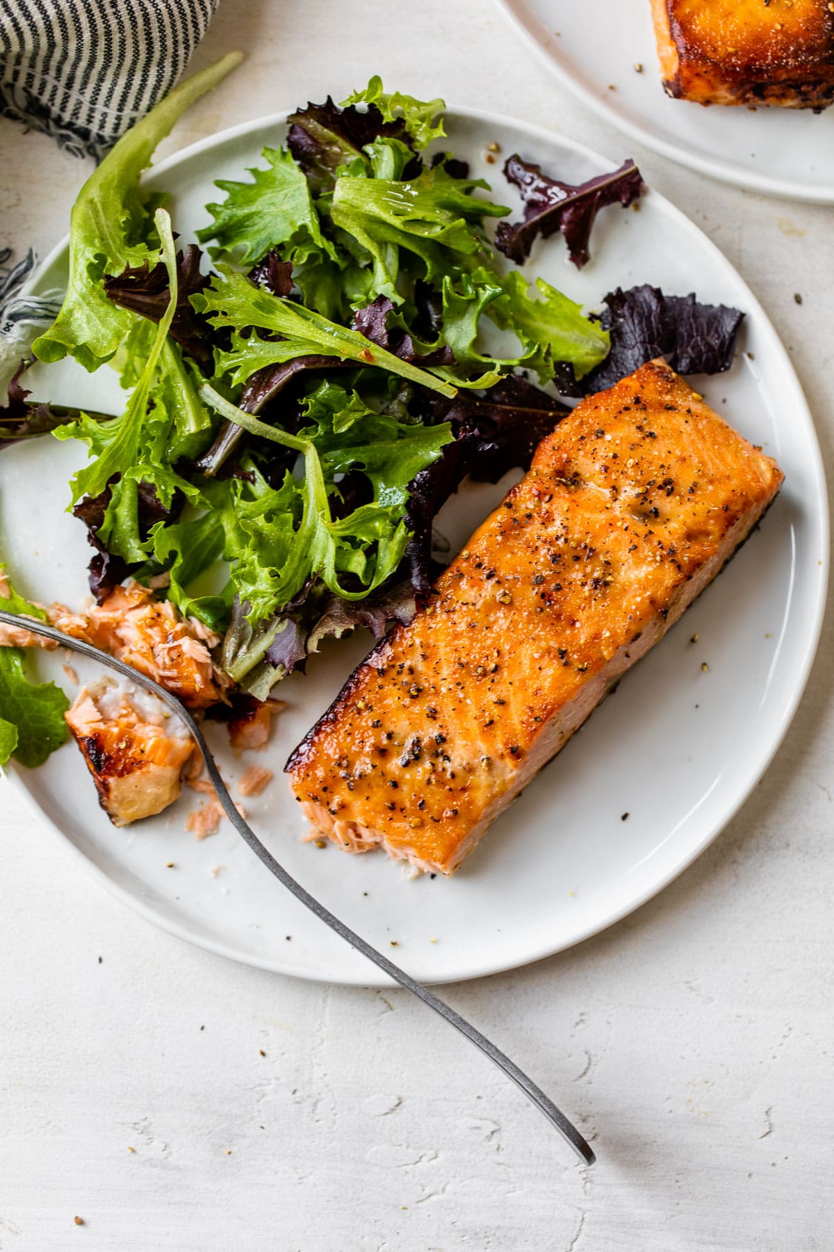Salad and air fryer salmon on a plate