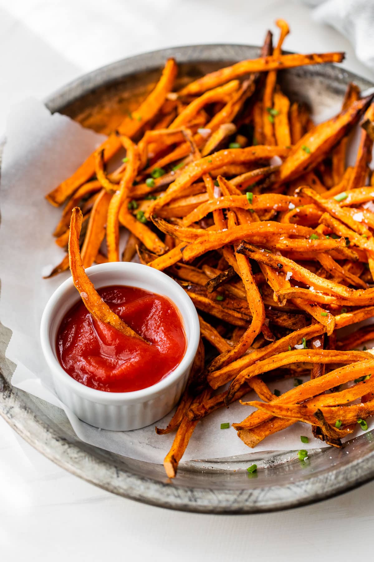 air fryer sweet potato fries on a plate with small bowl of ketchup