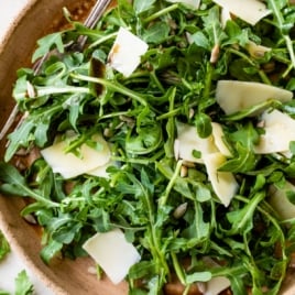 the best arugula salad recipe in a bowl