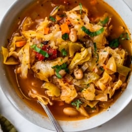 the best cabbage soup recipe in a bowl with a spoon