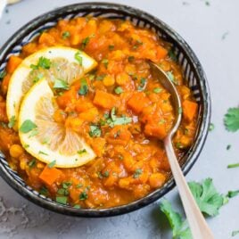 a bowl of red lentil curry carrot soup