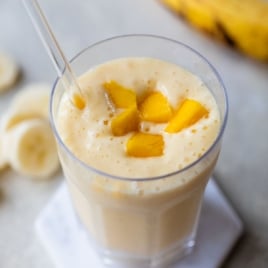 a cup of fresh mango smoothie with or without yogurt and milk