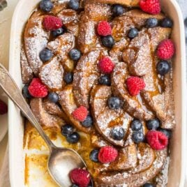 Overnight french toast bake in a baking dish with fresh berries