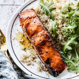 the best salmon marinade on a plate with rice and greens
