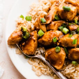 Bourbon chicken with rice on a white plate