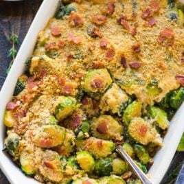An easy, healthy recipe for Cheesy Brussels Sprouts Gratin with Gruyere, Bacon, and Crispy Breadcrumb Topping. TO DIE FOR! Everyone loves this cheesy brussel sprout casserole recipe! Great for Christmas, Thanksgiving, or anytime you need a crowd-pleasing side dish. #gratin #brusselsprout #easy #healthy