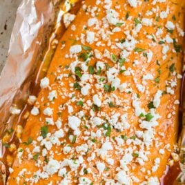 Foiled baked salmon with buffalo sauce and cheese crumbles