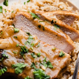 Juicy smothered pork chops with rice