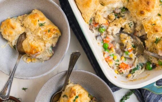 Chicken and biscuits in a baking dish and served in two bowls