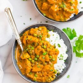 Chicken tikka masala in two bowls with white rice