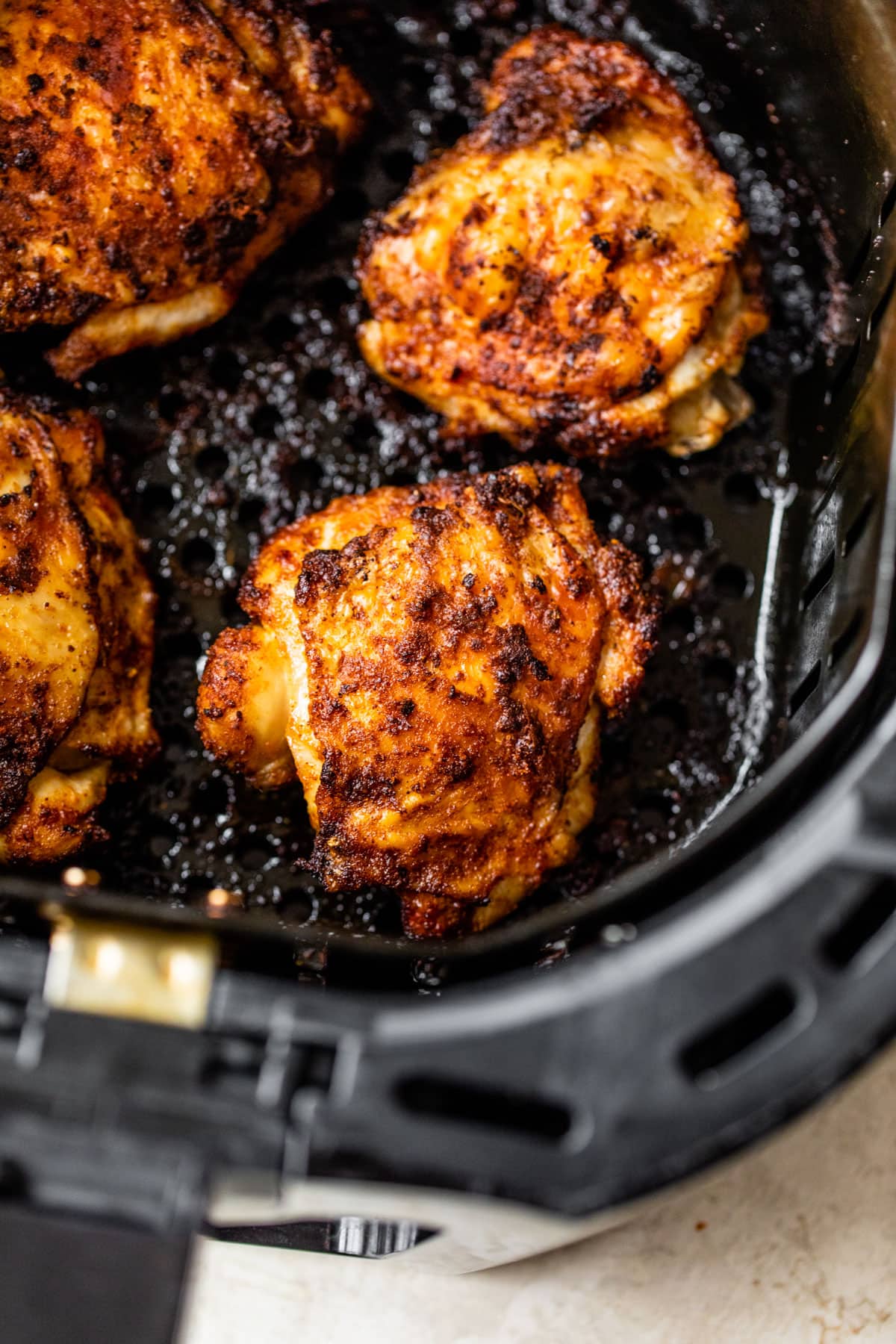 An air fryer with chicken thighs inside