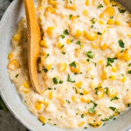 Crock Pot Creamed Corn in a bowl with a spoon, served as a easy slow cooker side dish