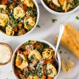 Italian Crockpot Tortellini Soup with sausage and kale. An easy, healthy crockpot recipe with chicken or turkey sausage, spinach or kale, and cheese. Creamy and comforting, this slow cooker Tuscan soup is one of the best crockpot recipes