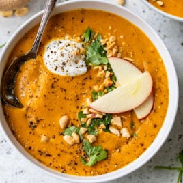 The best curried carrot soup recipe with apples and chopped peanuts on top