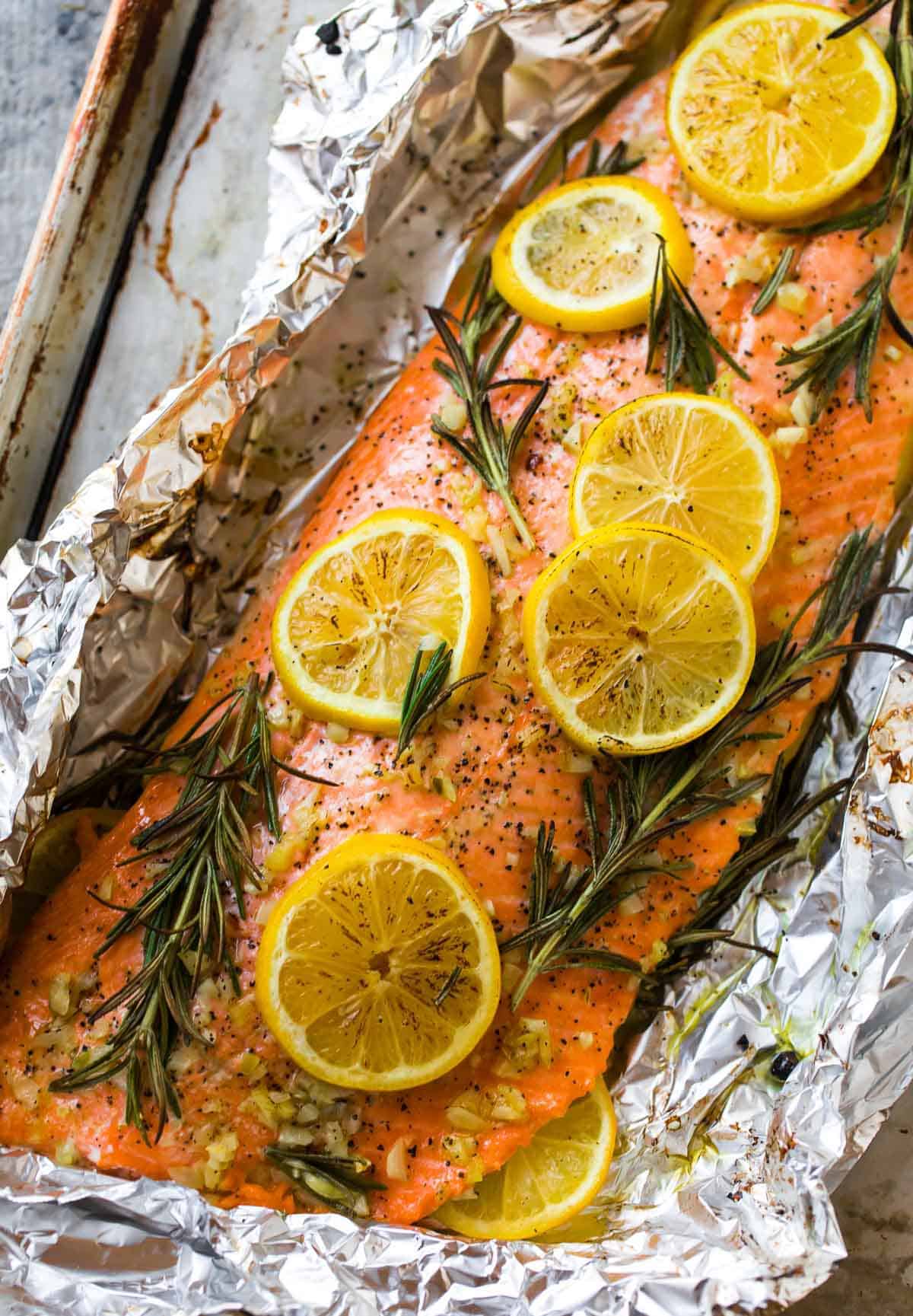 Healthy baked salmon in foil with lemon and herbs