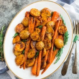 Perfect Roasted Potatoes and Carrots with Rosemary on a white plate