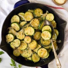 Easy Sauteed Zucchini with Onions and Parmesan. Golden, delicious zucchini and squash, cooked with butter, garlic, and your favorite seasonings. Healthy and simple, it's the perfect summer side dish!