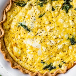 quick and easy spinach and feta quiche in a pie dish with crust