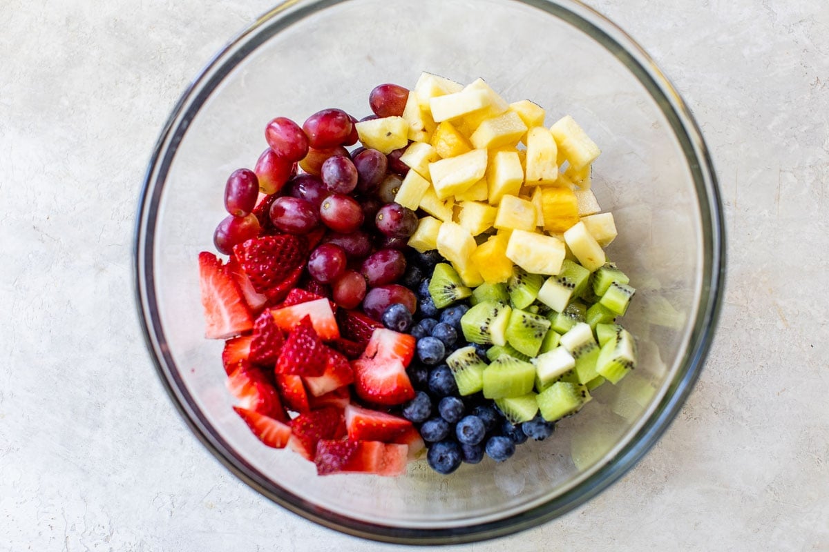 grapes, strawberries, pineapple, kiwi and blueberries in a bowl
