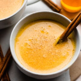 Soothing Bedtime Golden Milk recipe in a cup with a cinnamon stick
