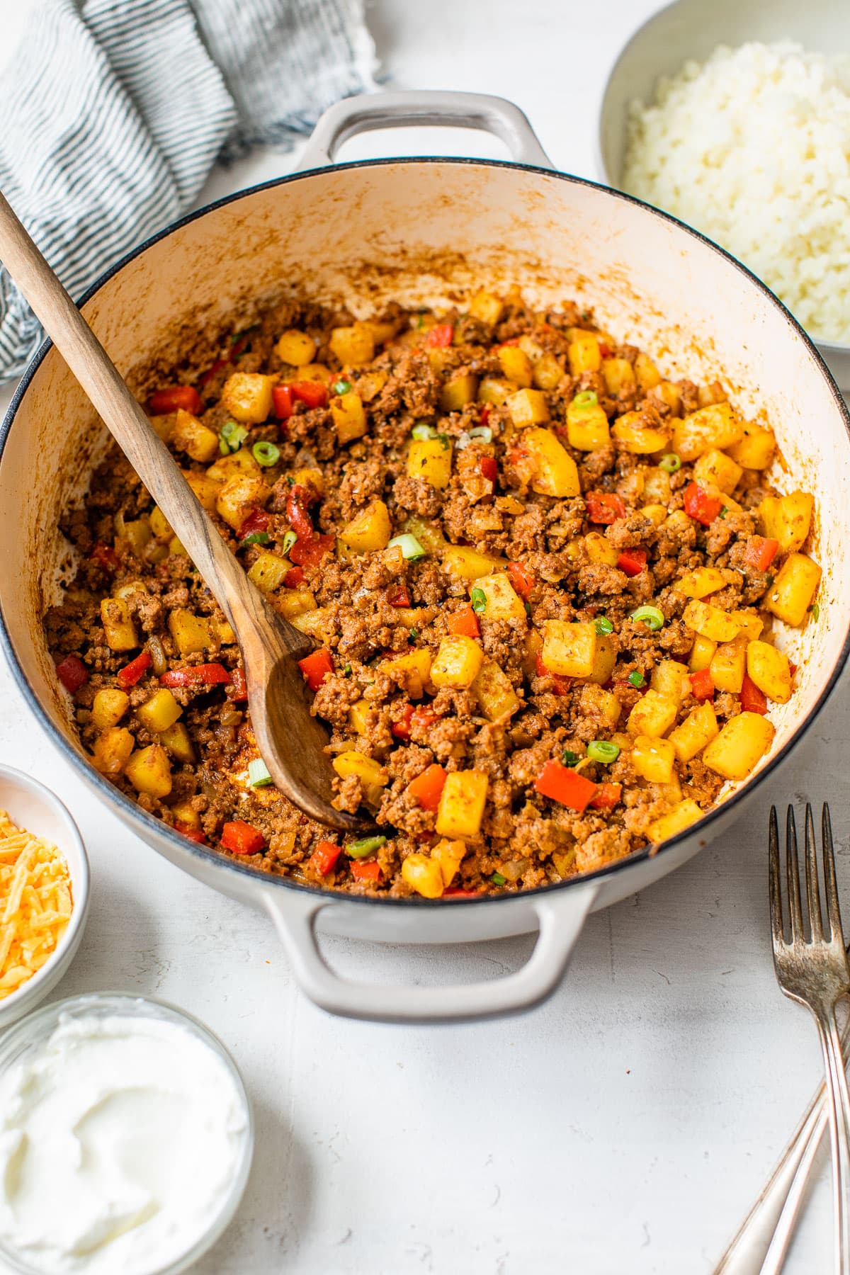 A pot with peppers, potatoes, and ground beef
