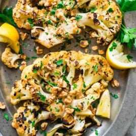 Grilled Cauliflower Steaks with honey, lemon, and toasted walnuts. Meaty, caramelized, and satisfying! Easy, low carb recipe that’s perfect for a simple side or light dinner. {can be made vegan; gluten free} Recipe at wellplated.com | @wellplated