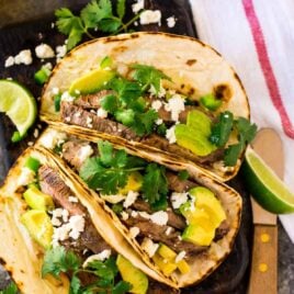 Easy Marinaded Flank Steak Tacos - Grilled, stove top, or oven flank steak tacos with the best citrus marinade. Fresh, quick, and healthy! You’ll love this carde asada recipe for simple dinners and it’s easy to make for a crowd.