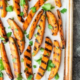 Sweet and spicy Grilled Sweet Potato Fries. The best, easiest way to make potato wedges on the grill. A healthy, gluten free side dish perfect for summer dinners! Recipe at wellplated.com | @wellplated