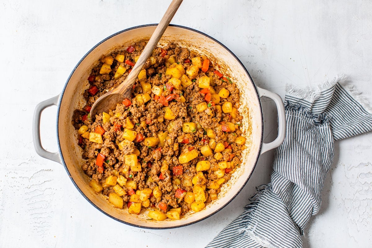 Ground beef with potatoes and peppers in a Dutch oven