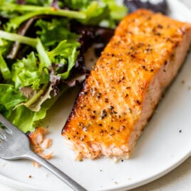 Air fryer salmon on a plate with salad