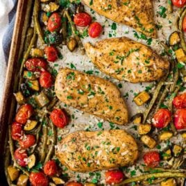 Baked Italian Chicken with Vegetables. Flavor-packed chicken breasts with tomatoes, zucchini, and any other fresh vegetables you love. Everything cooks on ONE PAN in the oven for an easy, healthy dinner! Great for meal prep and the the balsamic Italian chicken marinade is to die for.
