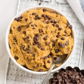 A white bowl with healthy chickpea cookie dough with chocolate chips