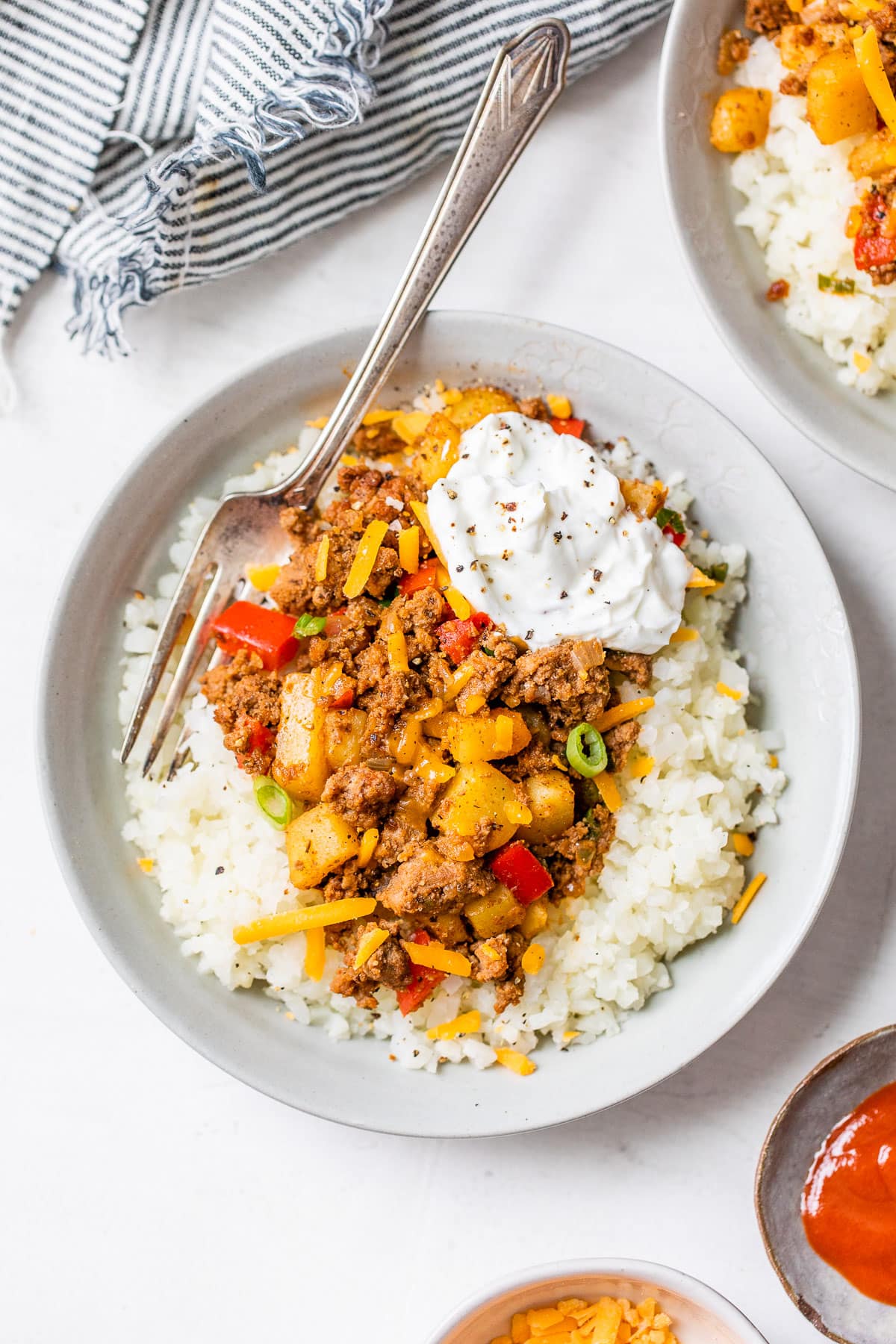 A bowl with ground beef, potatoes, and cauliflower rice
