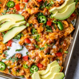 platter of healthy chicken nachos with shredded chicken and queso