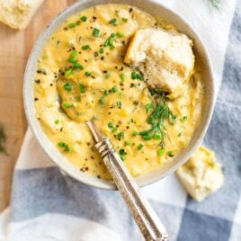 A bowl of Creamy Vegan Potato Leek Soup with bread