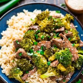 blue dinner plate of Asian beef and broccoli, made in a slow cooker