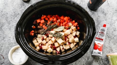 assembling crockpot beef stew with herbs
