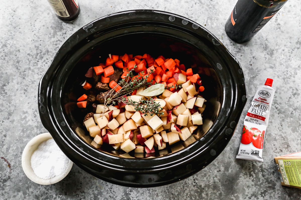 assembling crockpot beef stew with herbs