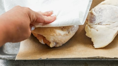 patting dry chicken thighs for smoker