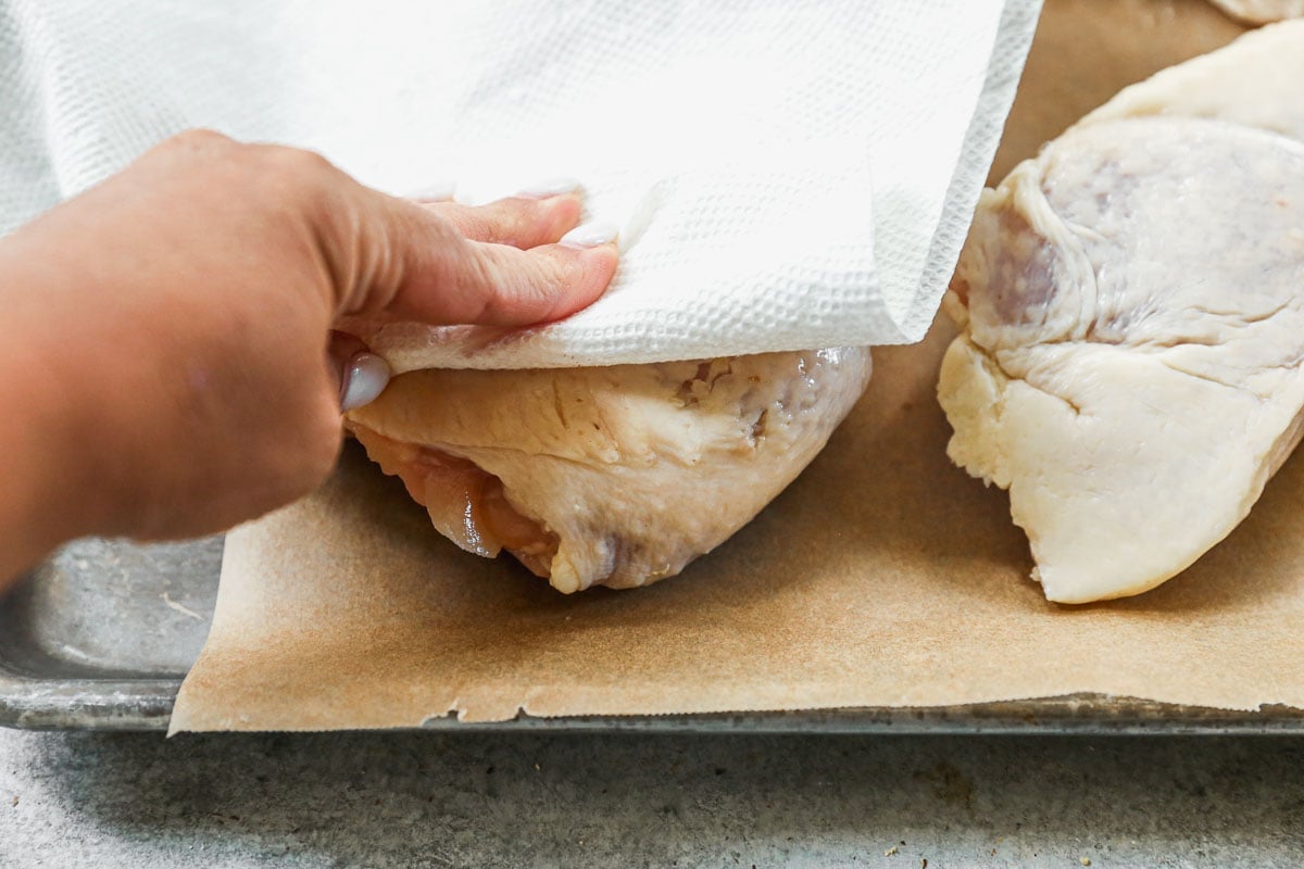 patting dry chicken thighs for smoker