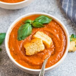 A bowl of Instant Pot tomato soup with croutons and basil