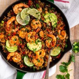 Healthy Mexican Shrimp and Rice. Easy one skillet dinner that's full of spicy Mexican flavor! Juicy shrimp, colorful veggies, whole grain brown rice, and black beans make this a true all-in-one meal.