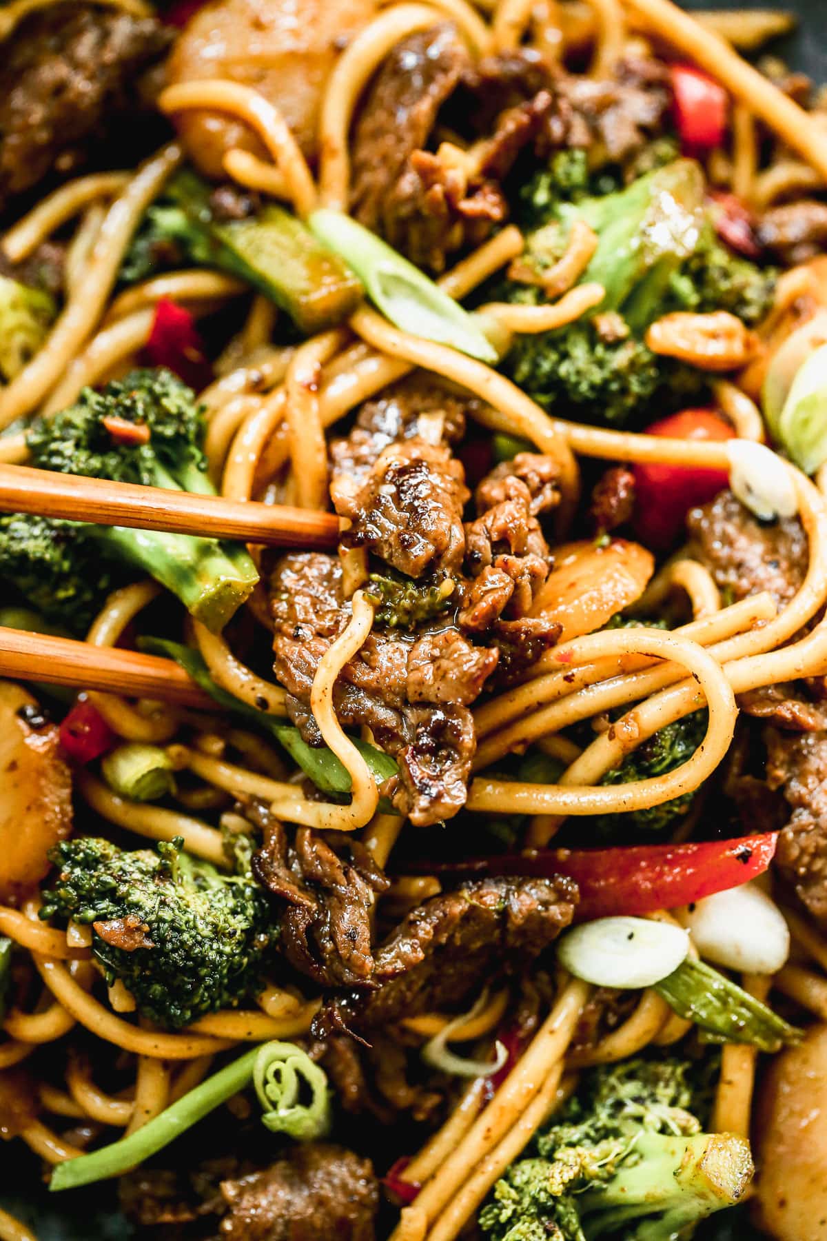 beef and broccoli lo mein with noodles on a plate