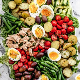 A big bowl of nicoise salad with capers